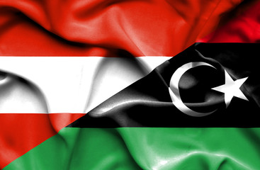 Waving flag of Libya and Austria