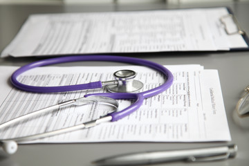 Stethoscope on the grey desk, close up