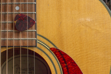 Naklejka premium Acoustic Guitar Sound Hole and Pick Royalty free stock photo