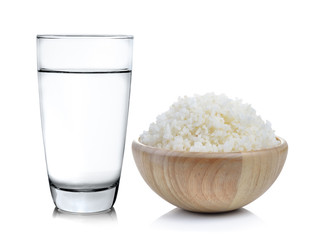 Rice in a wood  bowl and Glass of water on a white background