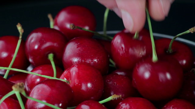 A Group of of Ripe Red Cherries Taken from a Beautiful Dish. Close up