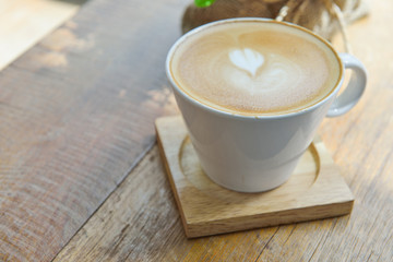 Hot latte coffee in glass  cup mug on wooden table