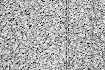 Background made from rusty metal mesh cage and stone in black an