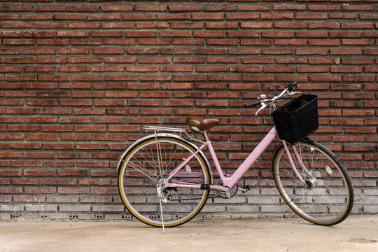 Vintage bicycle with old brick wall