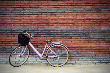 Fototapeta na wymiar Vintage bicycle with old brick wall