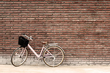 Fototapeta na wymiar Vintage bicycle with old brick wall