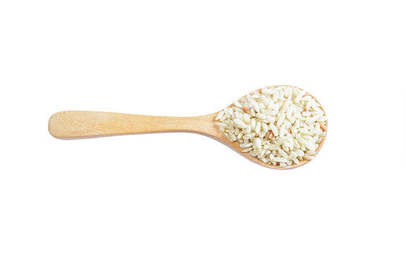Brown rice on wooden spoon isoleted on white  background. Produc