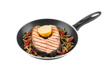 Frying pan with salmon steak