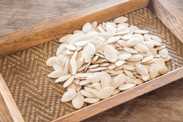 Pumpkin seeds on wooden tray