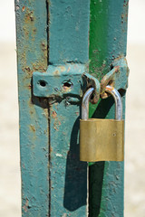 Padlock on the green metal door
