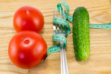 Cucumber and tomato with measuring