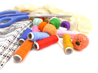 sewing kit background with color threads meter and scissors