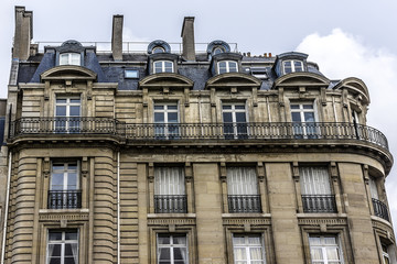 Traditional French house: balconies and windows. Paris, France.