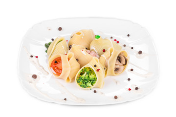 Pasta shells stuffed with vegetables and sausage.