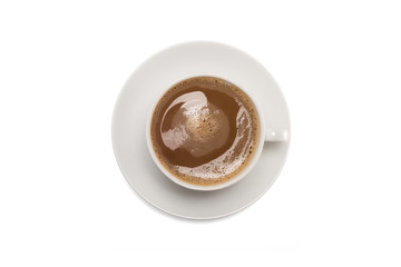 Overhead view of cup of coffee with saucer isolated on a white background.