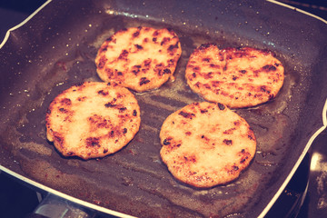Hamburgers in a grill pan ( Filtered image processed vintage eff