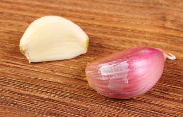 Cloves garlic on wooden table, healthy nutrition