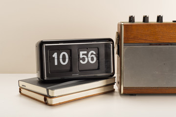 Old retro radio and flip clock with journals