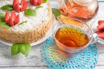 Celebratory cake with strawberries flowers and tea