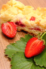 Fresh strawberries with leaves and piece of yeast cake