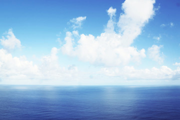 Perfect blue sea and cloudy sky over it
