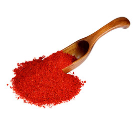 Powdered pimienta roja red pepper in the wooden spoon, isolated