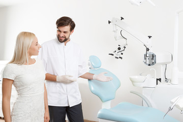 Dentist showing to client working place