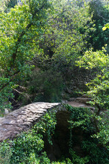 Rustic stone bridge over a stream in Cinque Terre, Italy