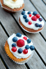 muffins with fruits on wooden ground