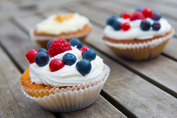 muffins with fruits on wooden ground