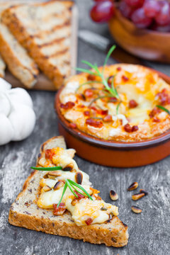 baked camembert with chorizo garlic rosemary fried pine nuts and