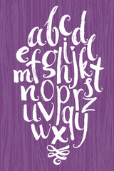 Vector alphabet. White letters written with a brush on a wood ba