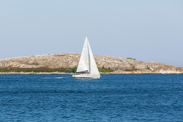 Sailboats at the rocky coastline