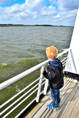 Fototapeta premium Boy on cruise ship dreaming about marine