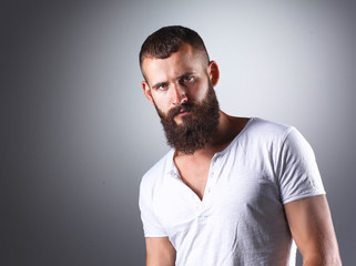 Obraz premium Portrait of handsome bearded man standing, isolated on grey