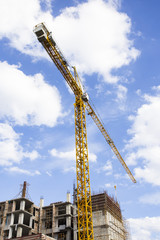 construction cranes and the blue sky with clouds