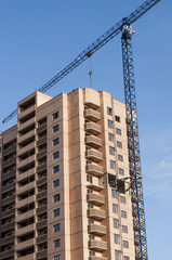 Fototapeta na wymiar Side view of the new buildings and high-rise crane