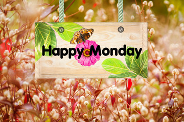 happy monday signpost in beautiful and white flora , red grass in the garden