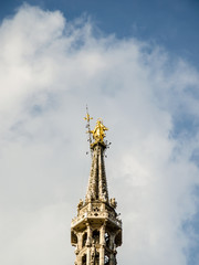 Fototapeta na wymiar the Madonnina. the virgin msry Golden statue on top of the highest spire of milan cathedral. the symbol of the city