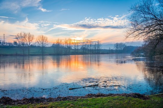 Icy frozen lake in winter at dawn at morning