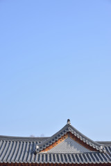 Fototapeta na wymiar tiled roofs of Gyeongbokgung with clear sky in Seoul, Korea