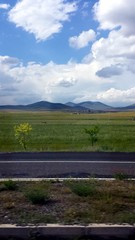 View of the road, fields and mountains