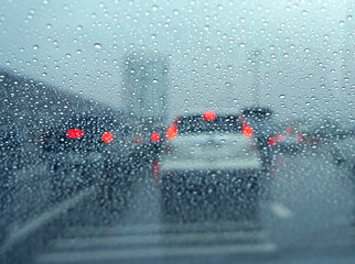 Car windshield in traffic jam during rain