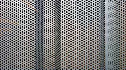 Metal wall profile with round holes as background
