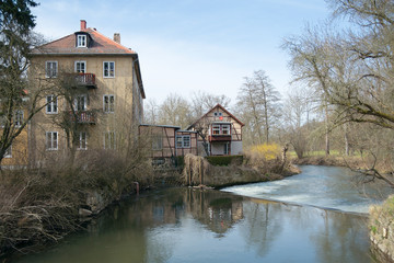 Fototapeta na wymiar Houses at dam on Ilm river, Weimar