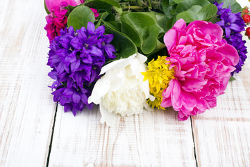 bouquet of colorful flowers on white wooden planks