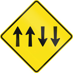 Warning road sign in Australia - Opposing traffic with two lanes in each direction