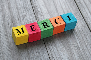 word merci (thank you in french) on colorful wooden cubes
