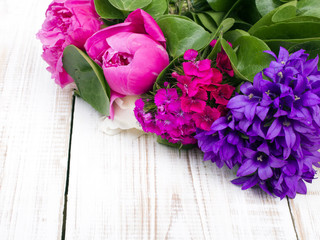 bouquet of colorful flowers on white wooden planks