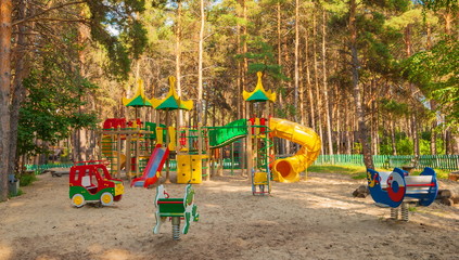 Children's playground with slides and swings in the park